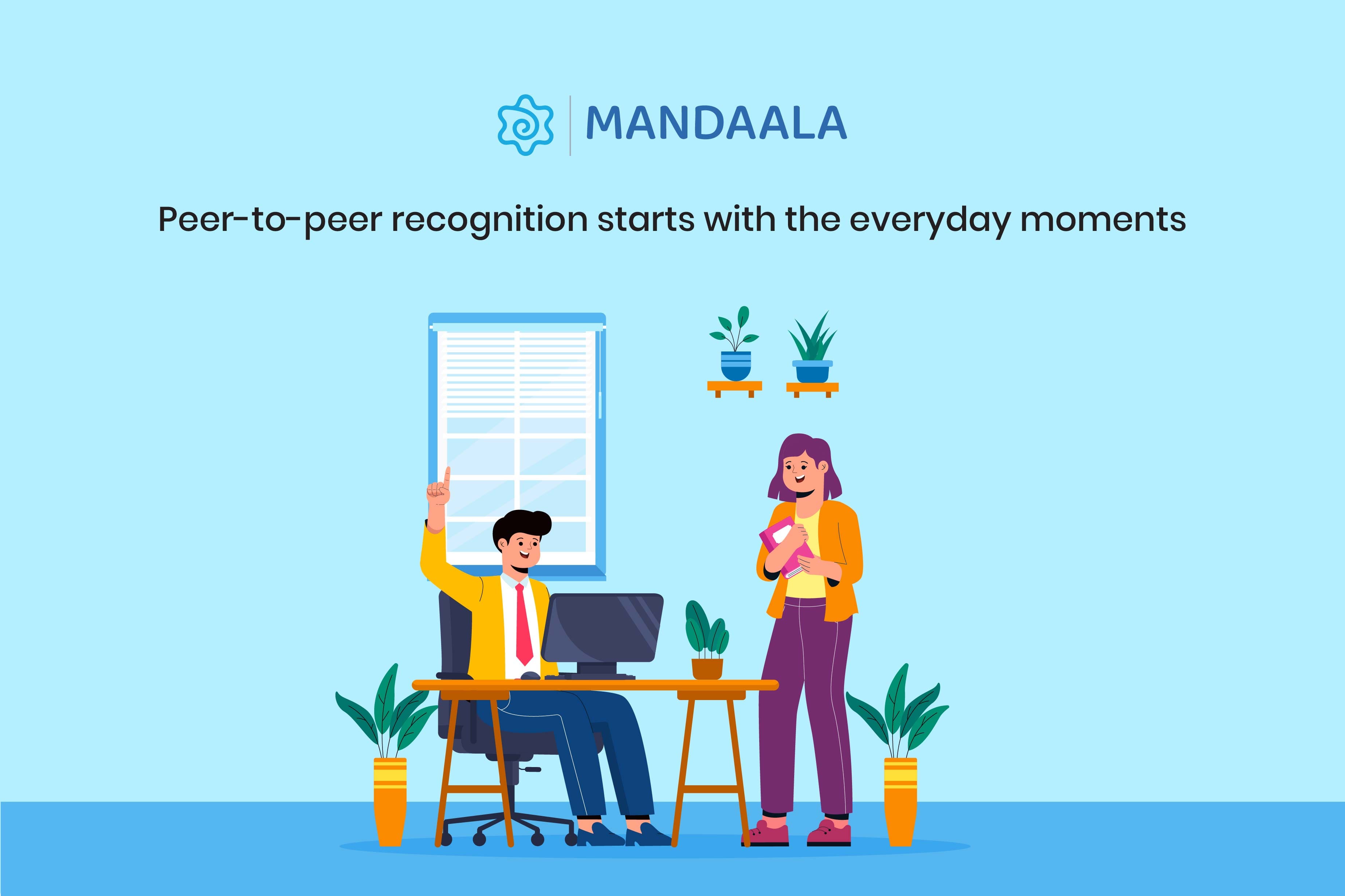 Colleague pointing in appreciation while seated at a desk, as another team member smiles nearby, capturing a casual moment of recognition.