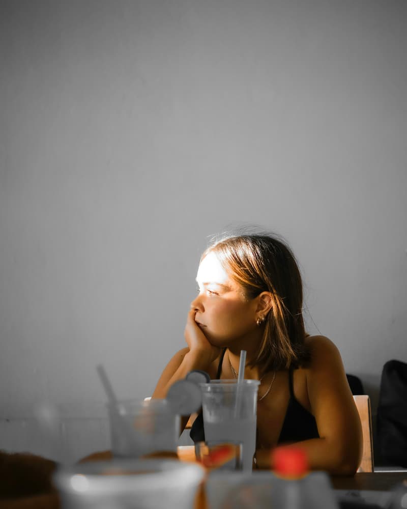 Woman with hand on chin looking away