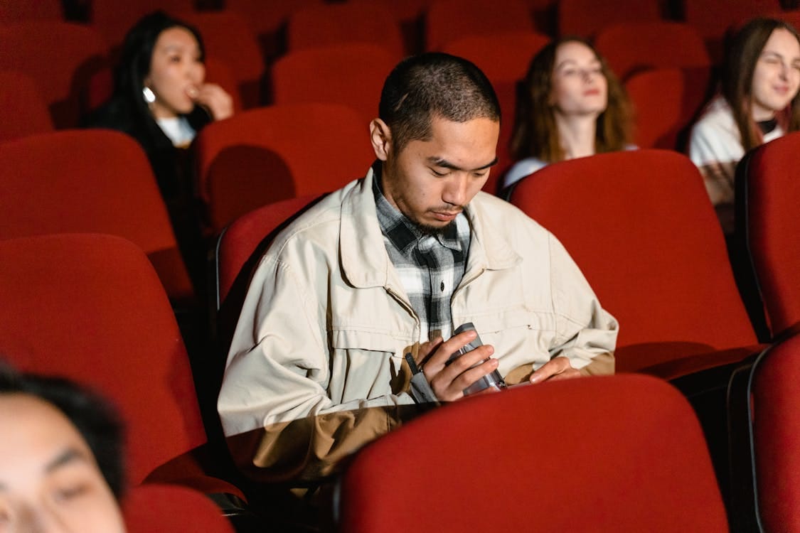 Man inside theater glancing at camera, illustrating short video engagement and attention span