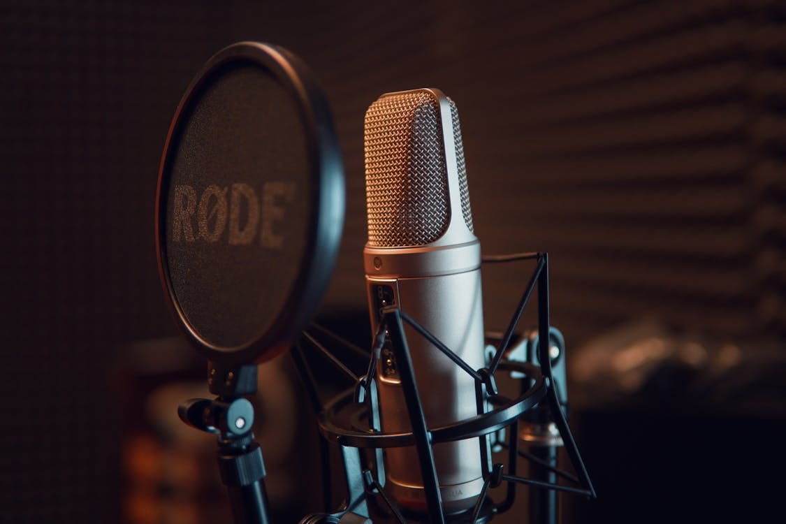 Free Close-up of a studio microphone with pop filter, ideal for recording audio. Stock Photo