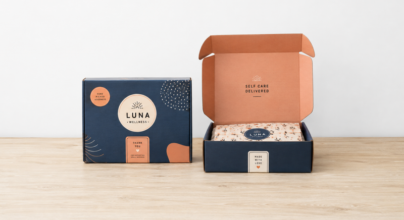 Two blue custom mailer boxes and one box with a message on the inner lid.