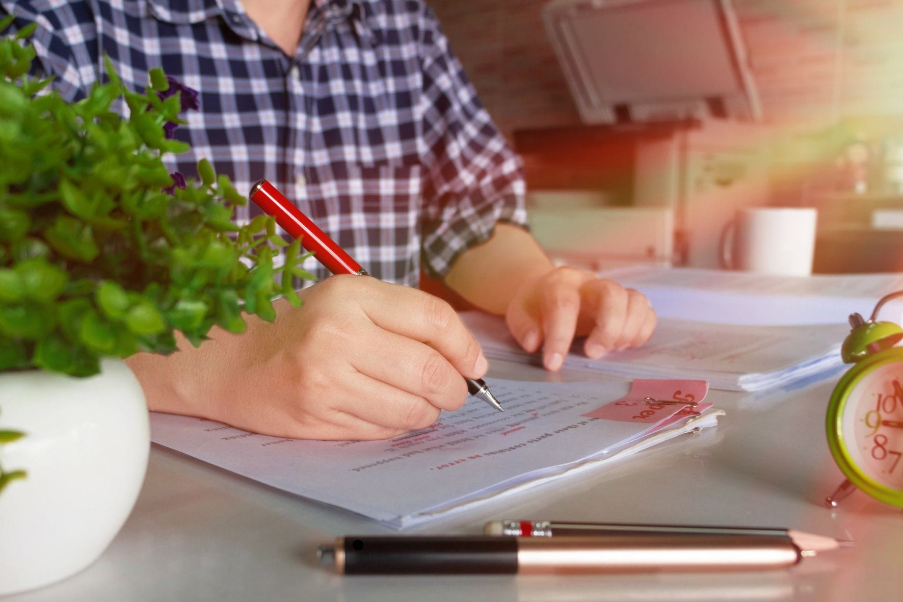 man writing on papers