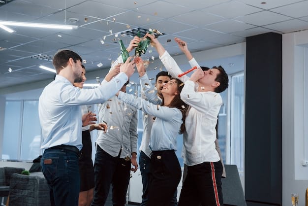 Hands up. Photo of young team in classical clothes celebrating success while holding drinks in the modern good lighted office