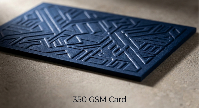 Premium thick business cards with velvet lamination fanned on dark marble surface labelled 350 to 400 GSM