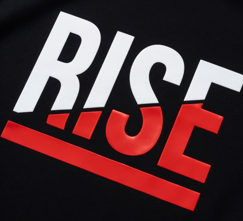 Spot colour screen print on black t-shirt showing sharp solid white and red logo with raised ink texture