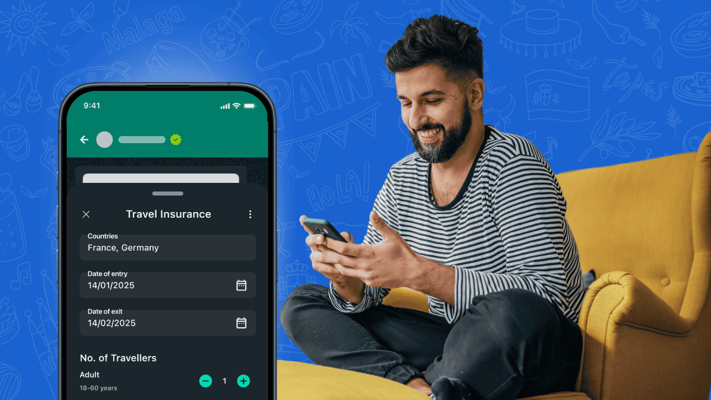 A man sitting on his couch and booking his travel insurance