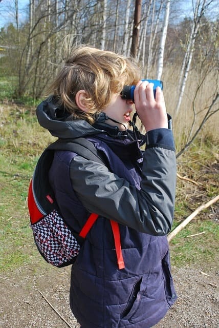 boy watching through binocular