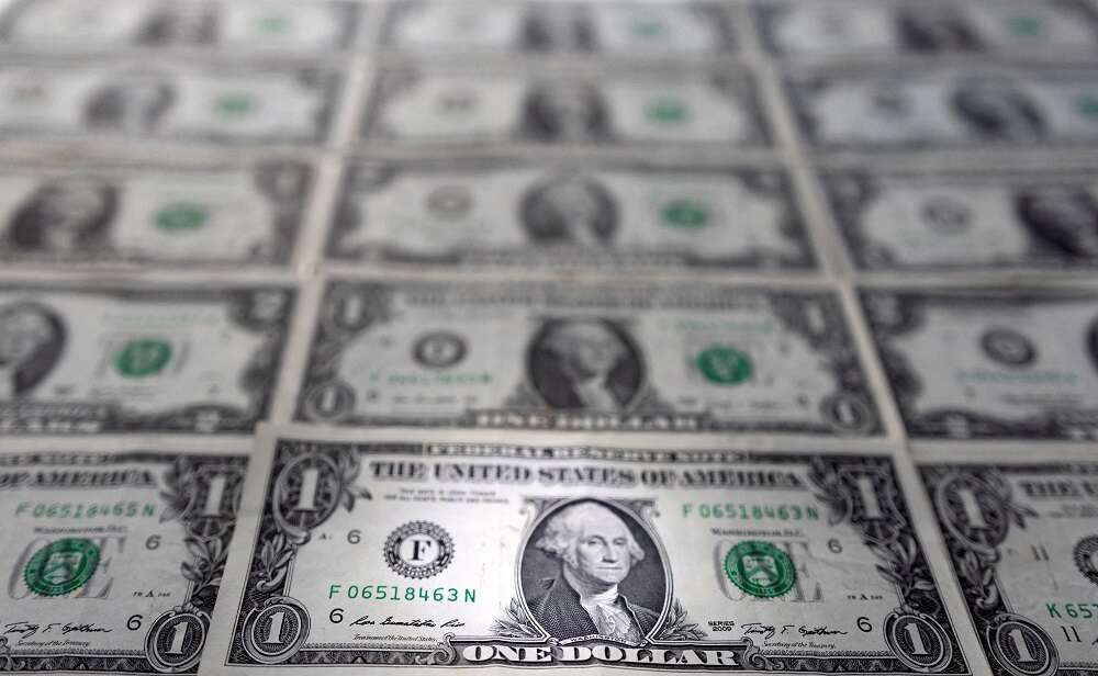 Dollar slides from near two-year high amid hawkish signals from Fed