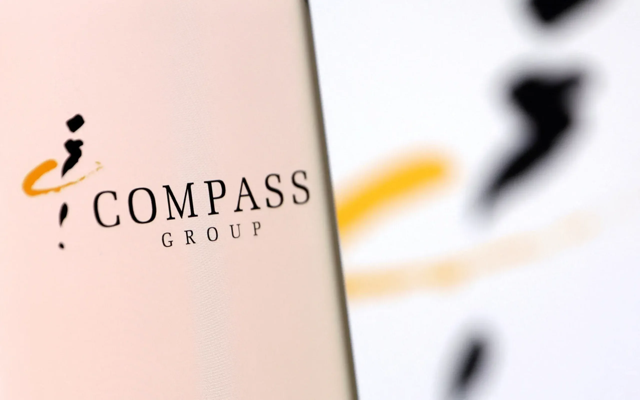 Catering firm Compass lifts profit forecast after strong first half