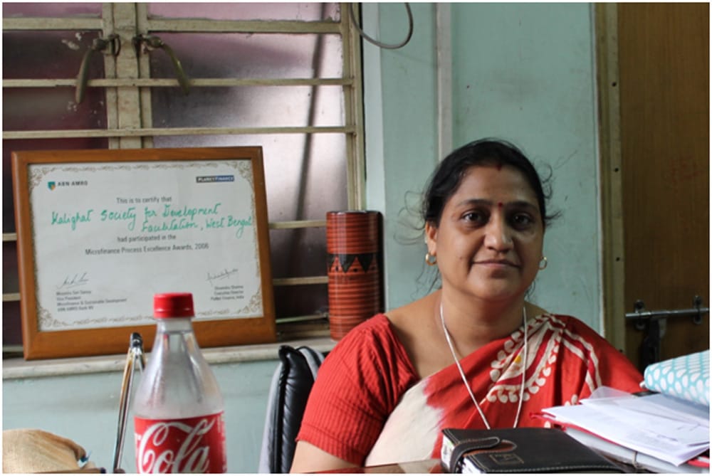 Indian woman at Kalighat Society being trained on digital payment system by MoneyOnMobile.