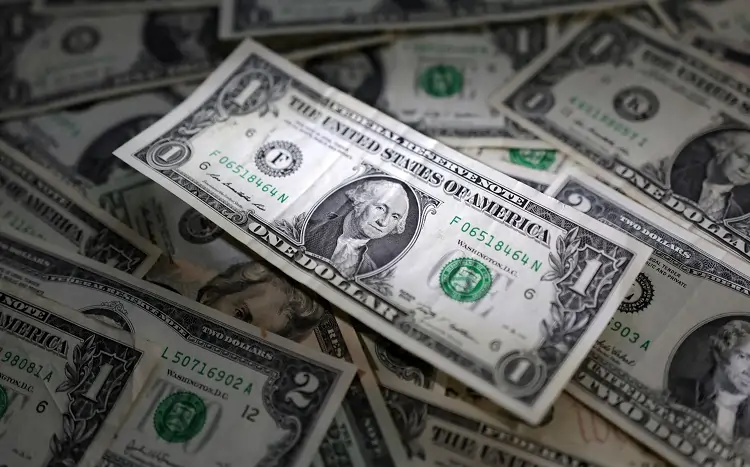 Dollar holds steady despite rate cut bets; Aussie rises after jobs data