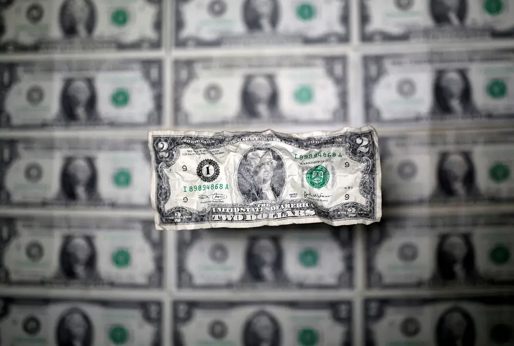 Dollar edges lower, traders focus on data for Fed clues