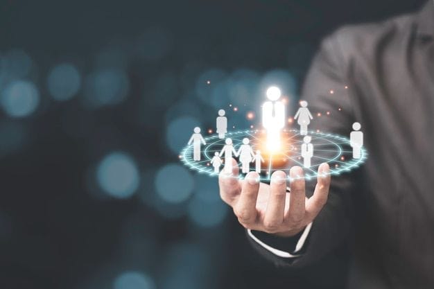 This may contain: a man in a business suit is holding out his hand with a group of people on it