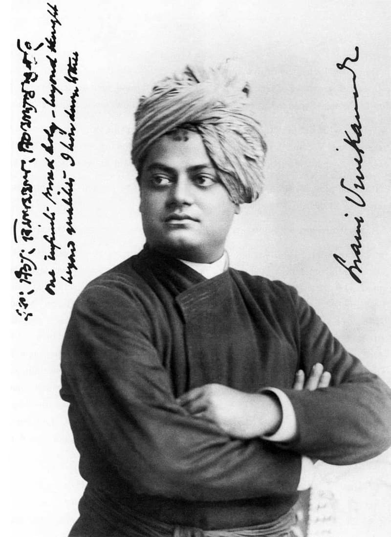A real black-and-white photo of Swami Vivekananda with crossed arms.