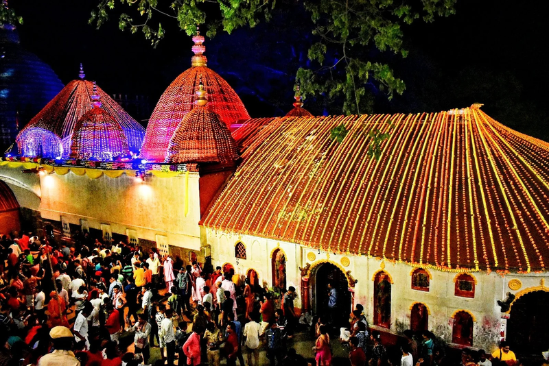 A photo of the Kamakhya Temple during the Ambubachi Mela festival at night.