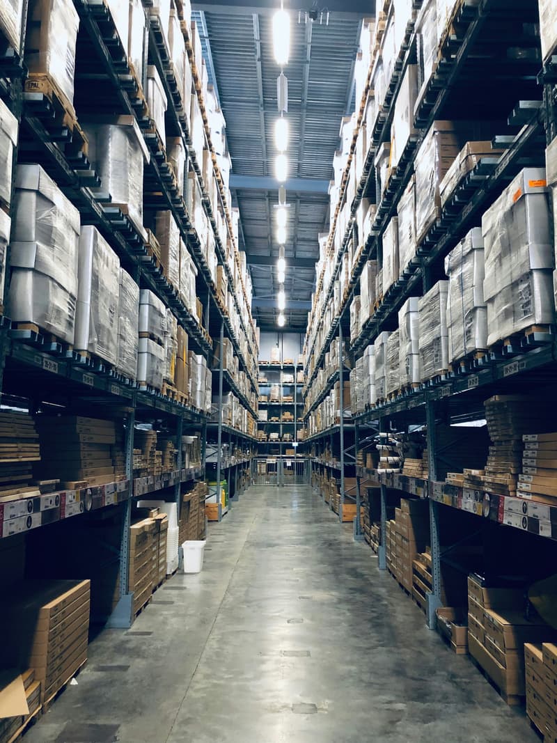Amazon FBA warehouse packages piled up representing return fee costs