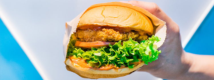 Person holding a burger