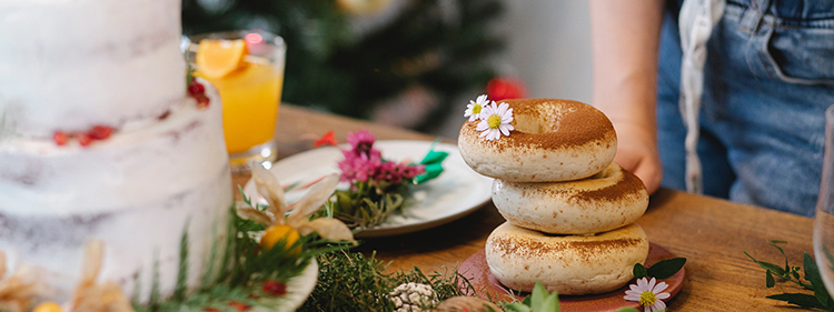 Pile of bagels with edible flowers on it