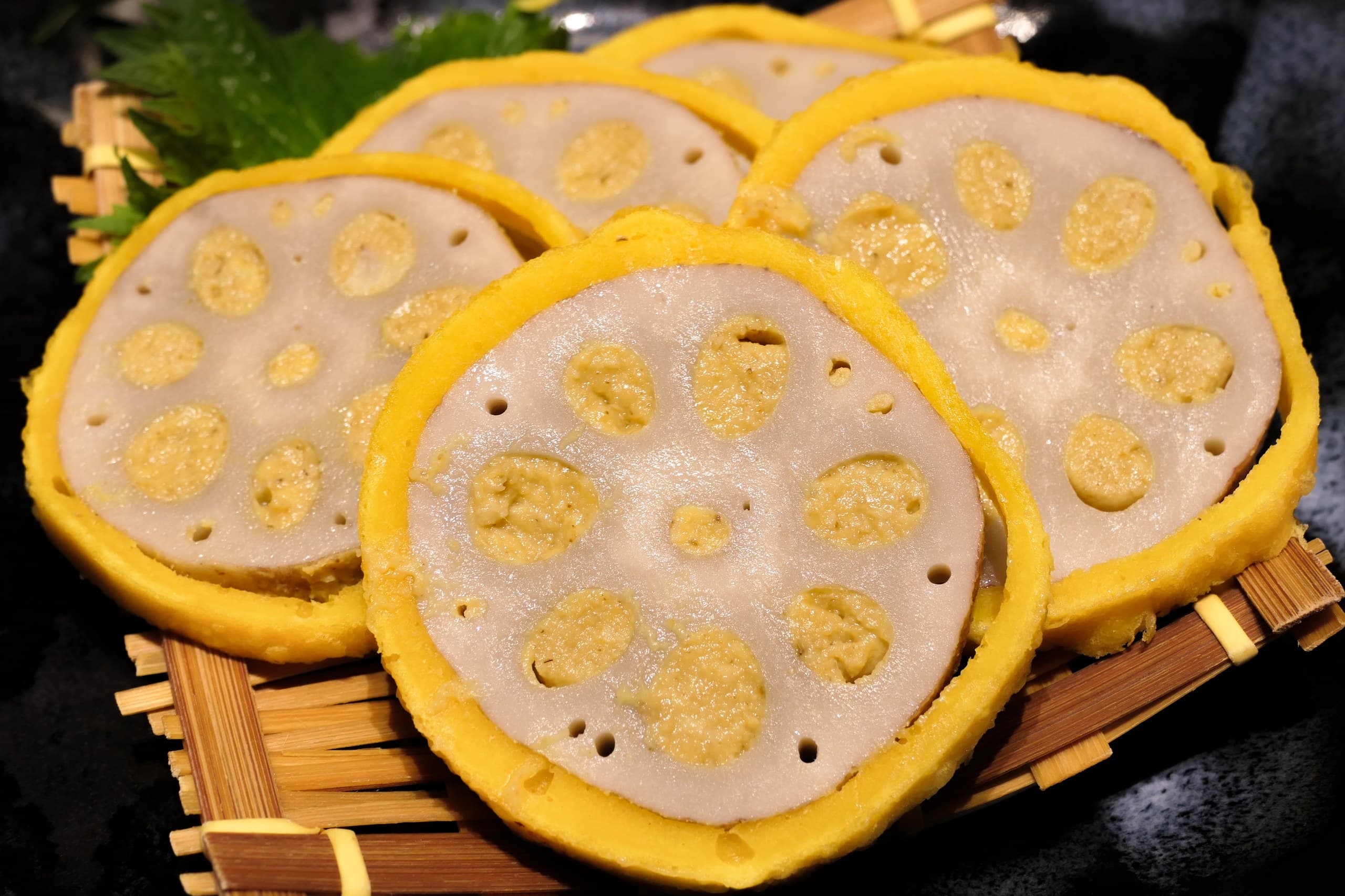 Sliced lotus root (karashi renkon) served on a bamboo tray