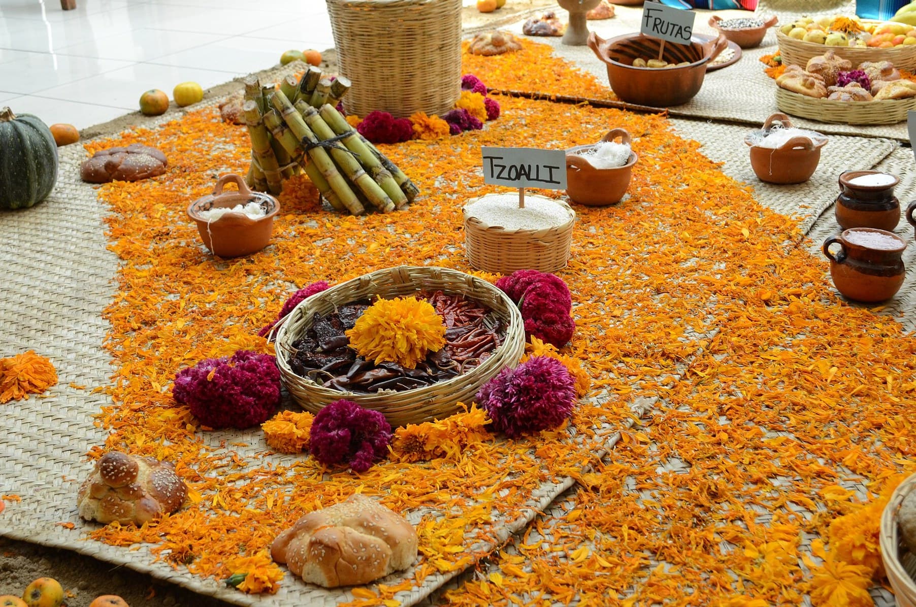 Day of the Dead ofrenda decorated with orange marigold petals
