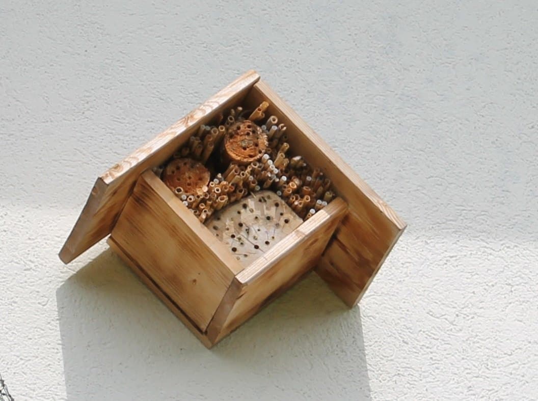 Small wooden insect hotel with drilled nesting holes
