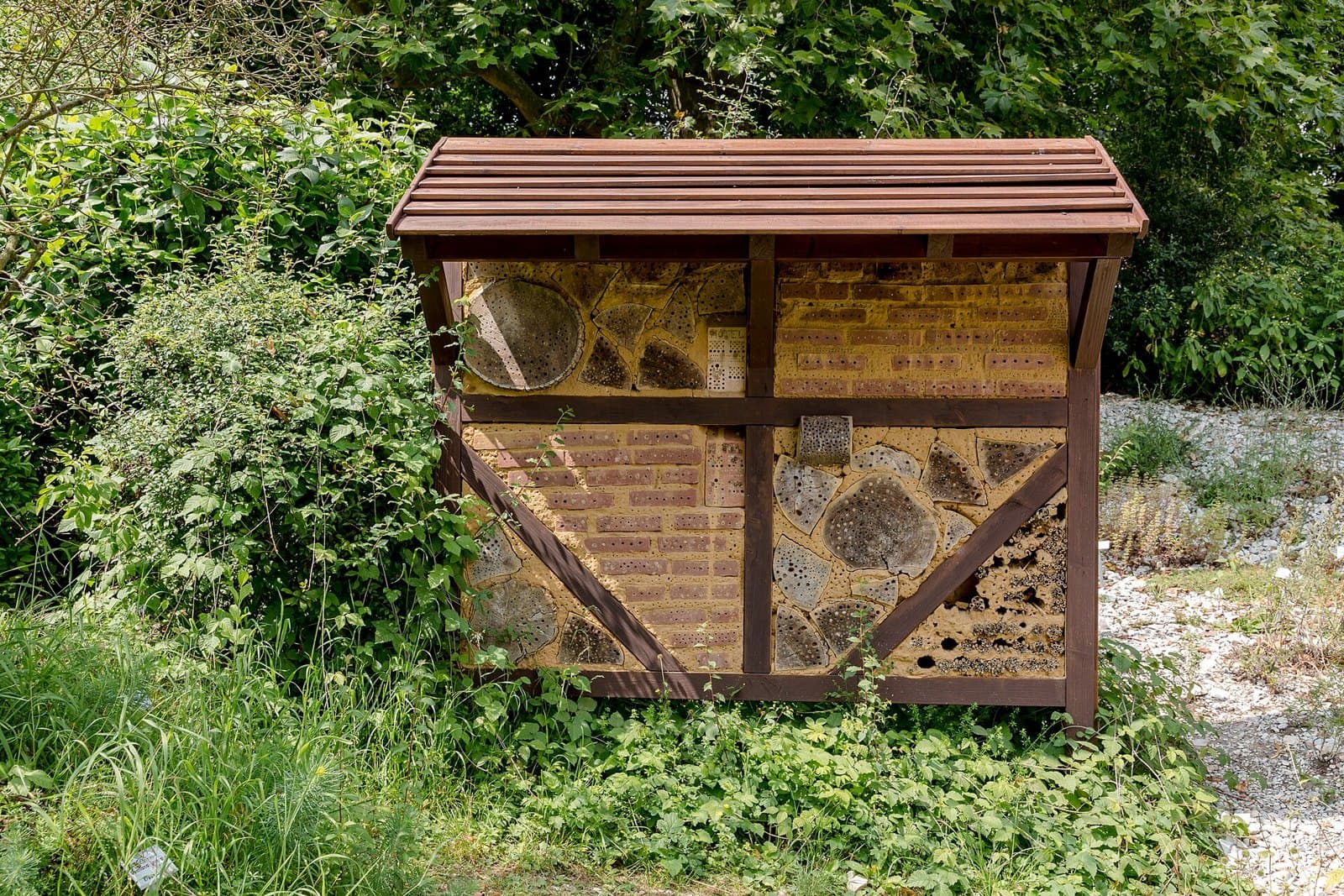 Large wooden insect hotel in a botanic garden