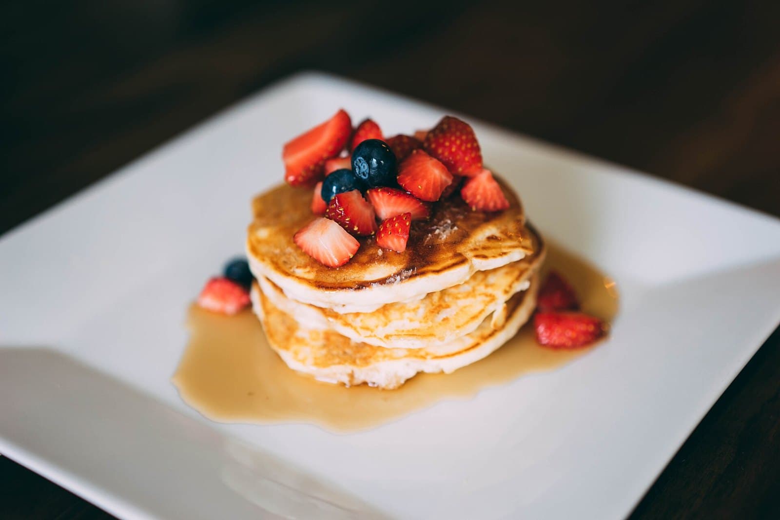 Stack of pancakes topped with berries