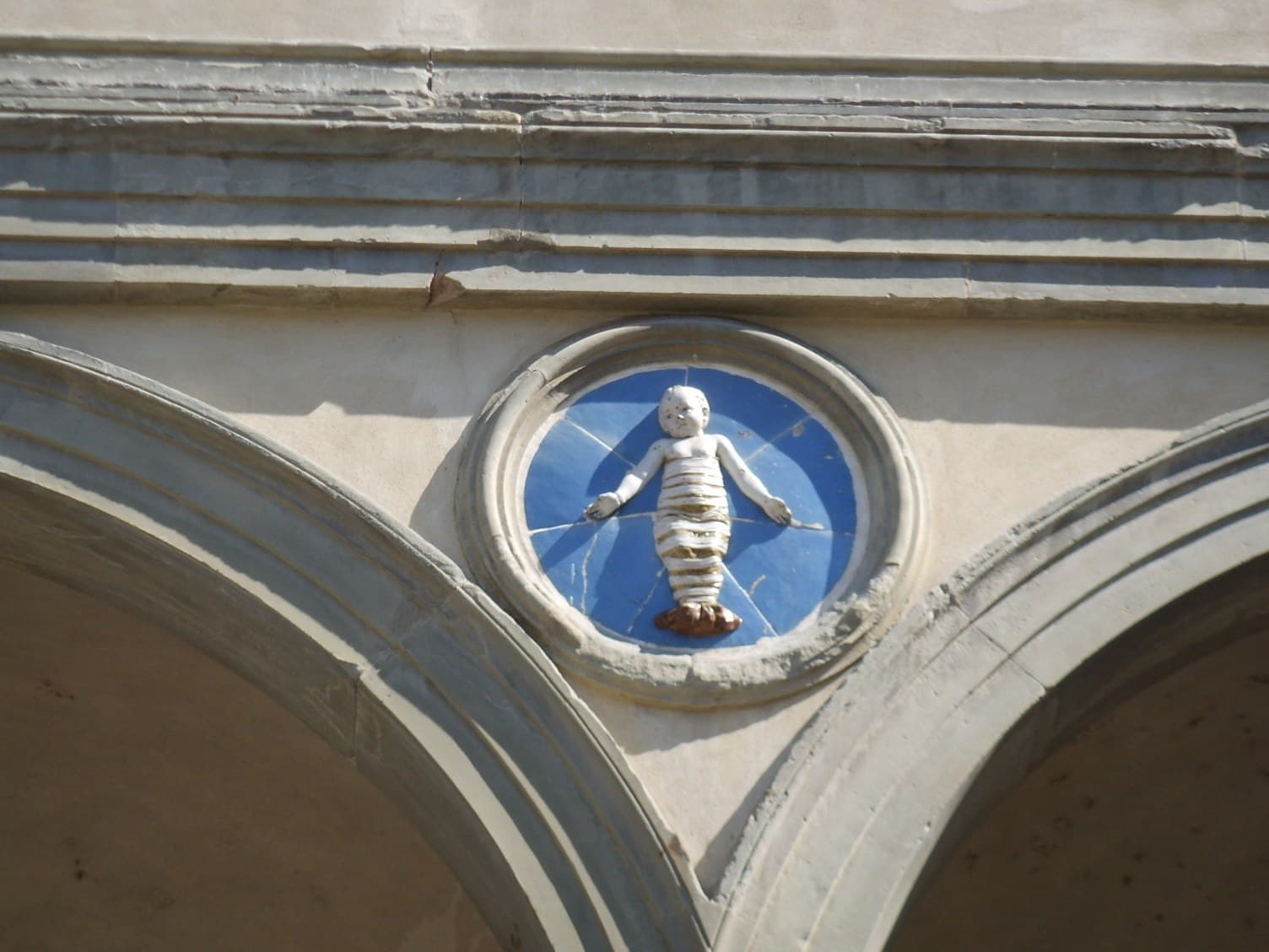 Della Robbia glazed terracotta roundel with a fruit-and-flower wreath, Florence