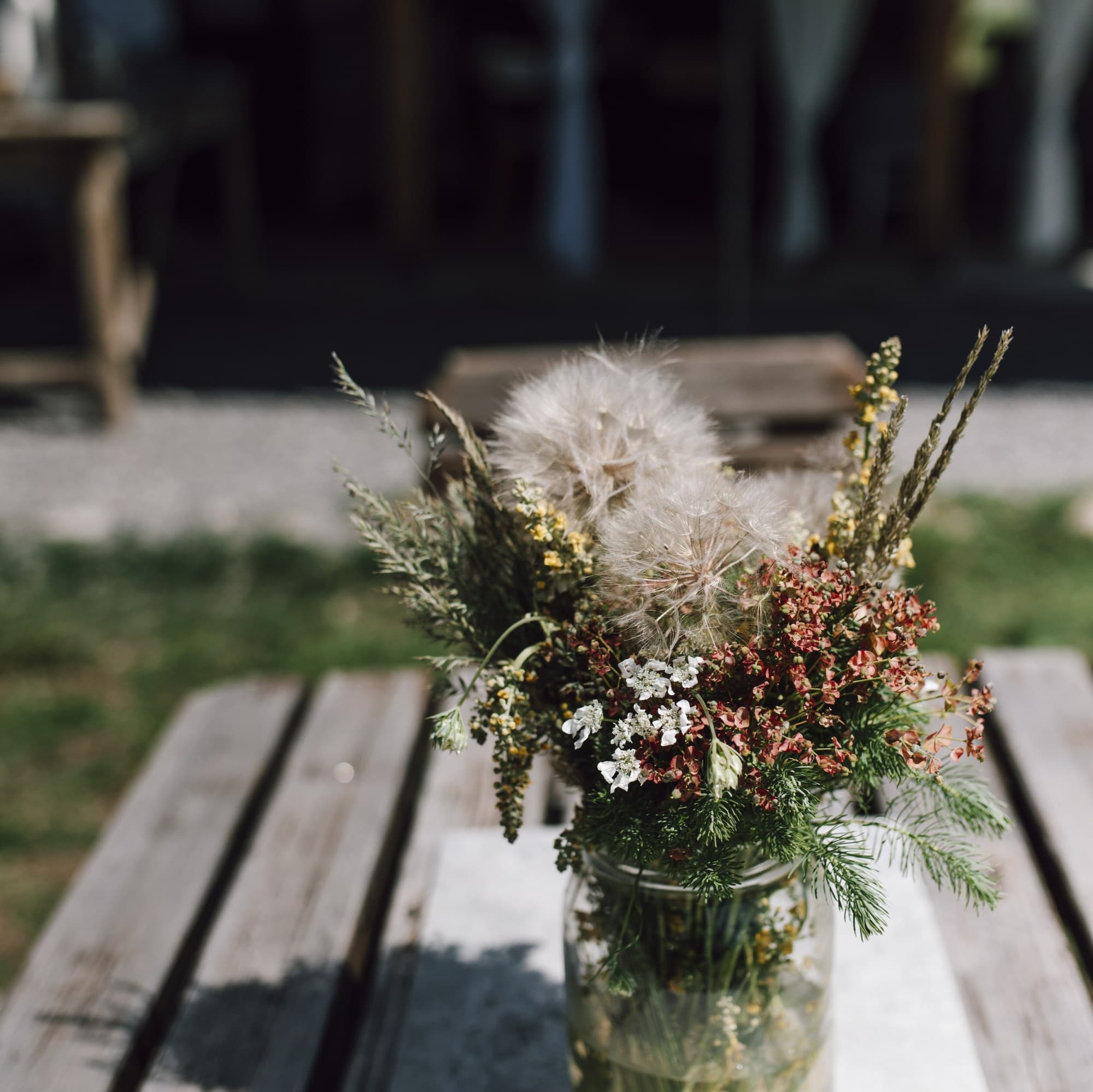 Modern mixed flower arrangement in a glass jar