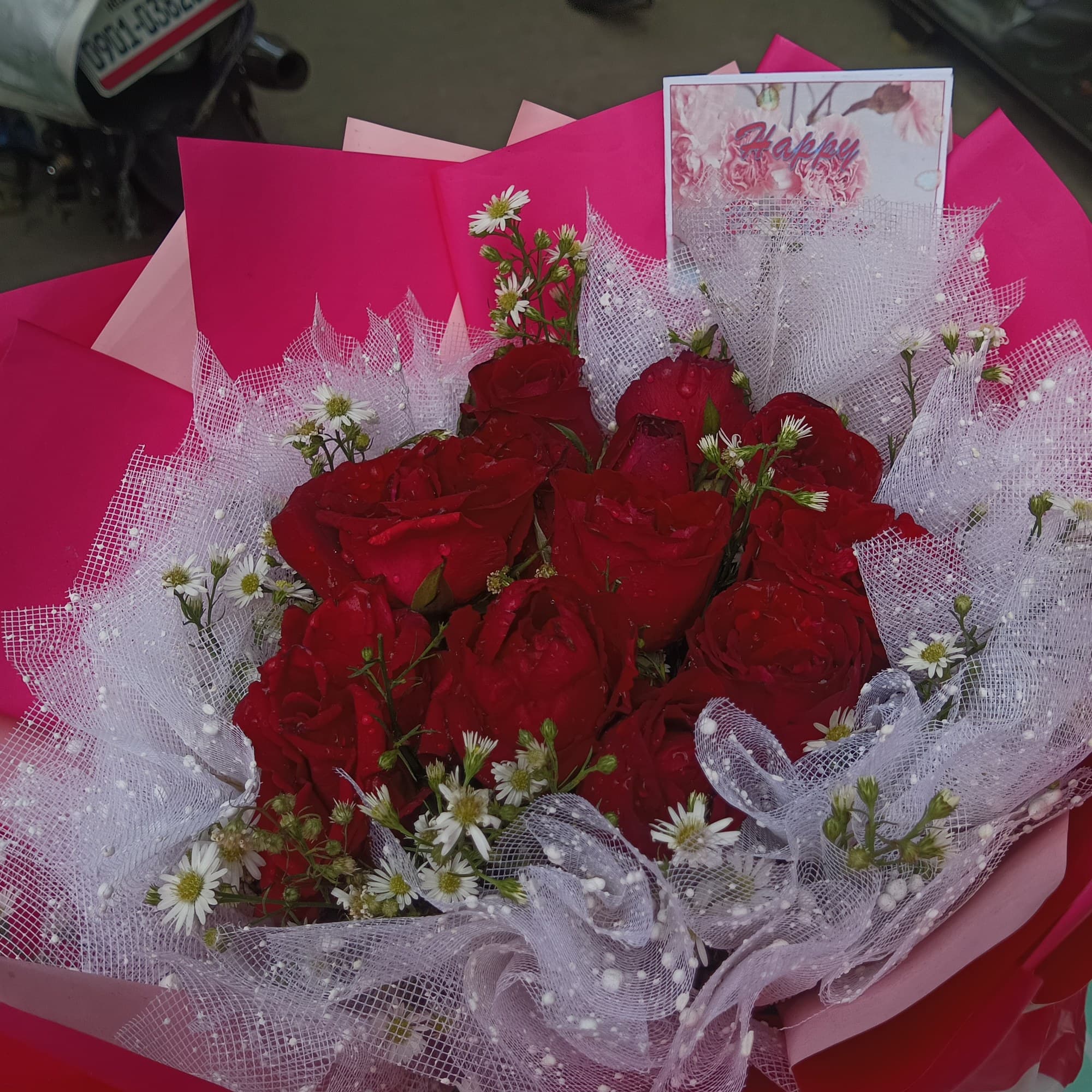 Bouquet of red roses wrapped in decorative paper