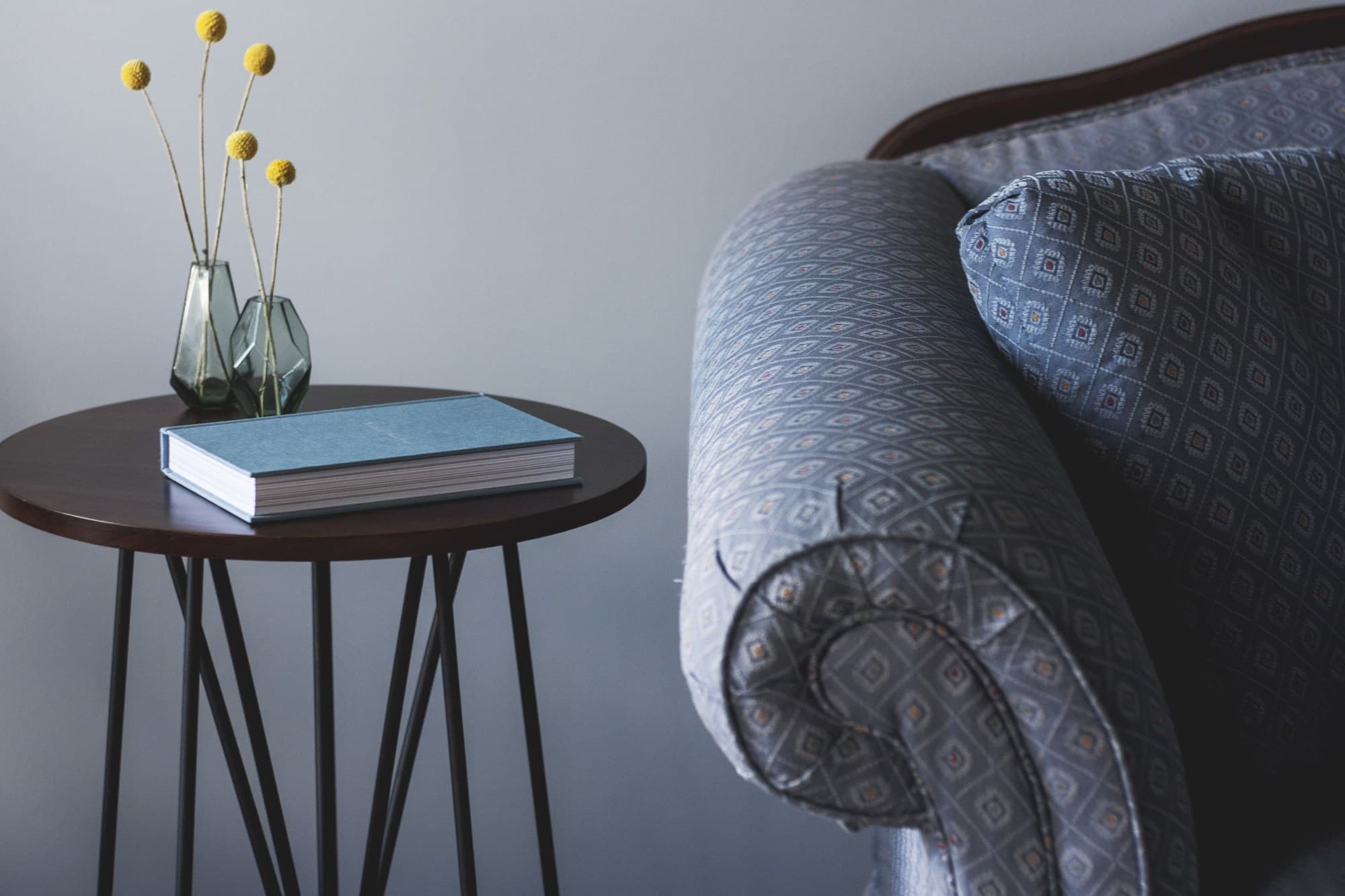 Books and a vase of flowers on a side table