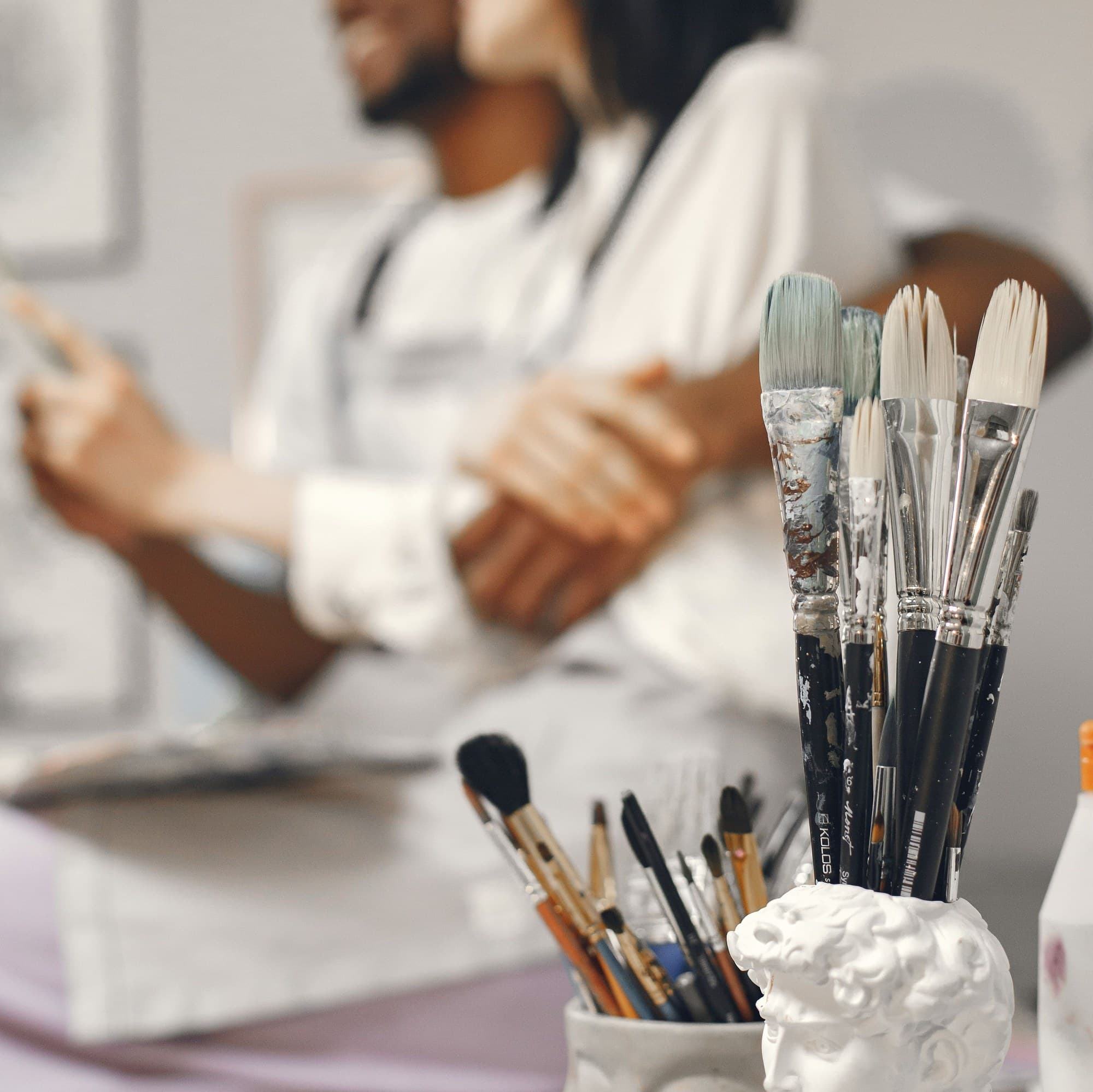 Paintbrushes in a jar in an art studio