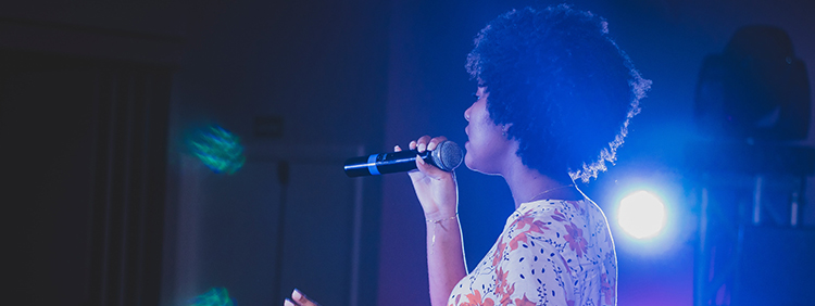 Woman singing with Karaoke Microphone
