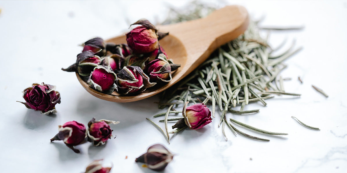 Red and White dried flowers on wooden spoon