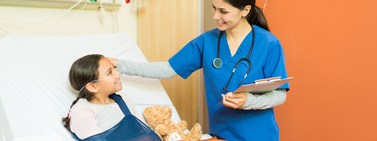 Smiling healthcare professional holding reports while looking at a little patient with fractured hand resting at hospital