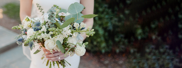 Bride holding white and green flower bouquet