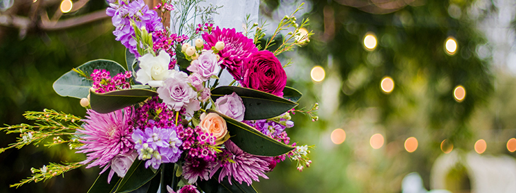 Side arch arrangement for a wedding suite with pink and purple flowers