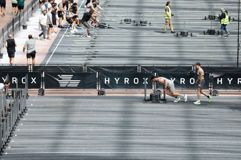 Athletes compete in a hyrox race event.