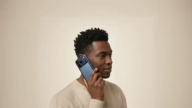 A man holding a phone with a Pocket attached to his ear during a call