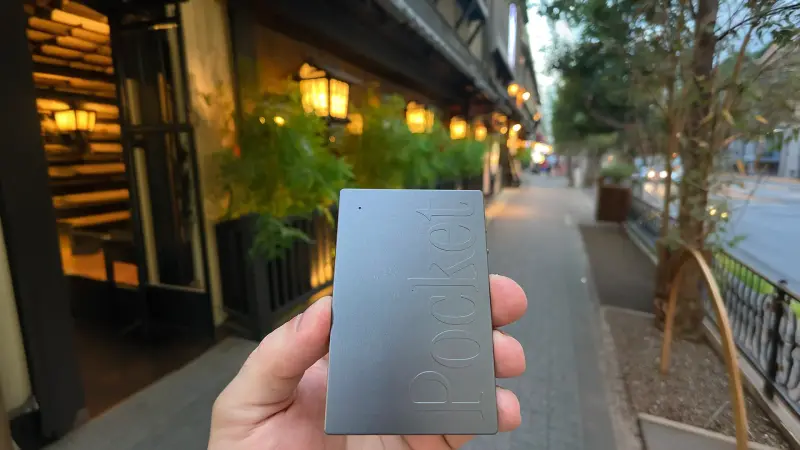 A space grey pocket device in a user's hand, very popular for its thin and sleek form factor.